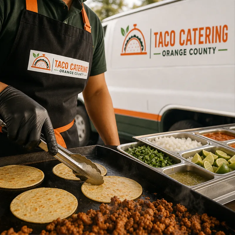 Tortillas and grilled meat on a flat top beside cilantro, onion, limes, and salsas